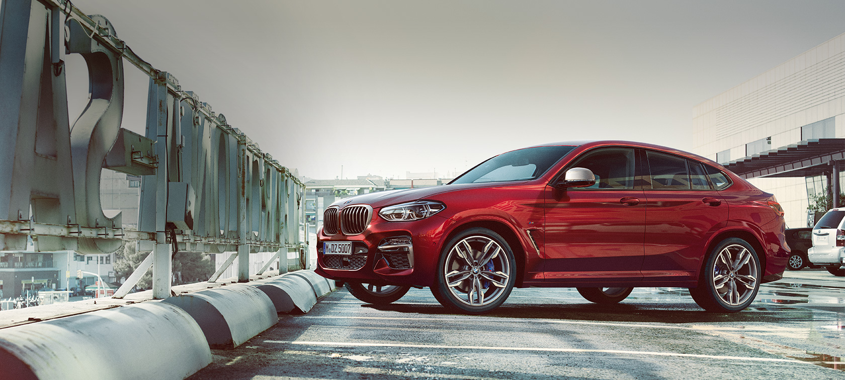 BMW X4 M40i G02 2018 Flamenco Red brilliant effect side view parking on parking deck